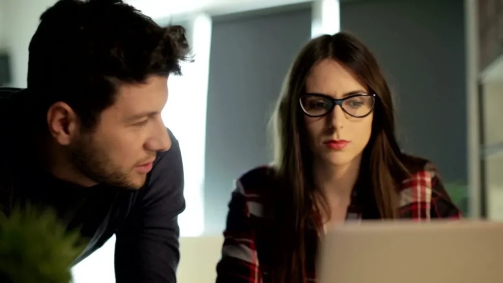 Finance professional analyzing real-time data on a laptop in a cozy workspace